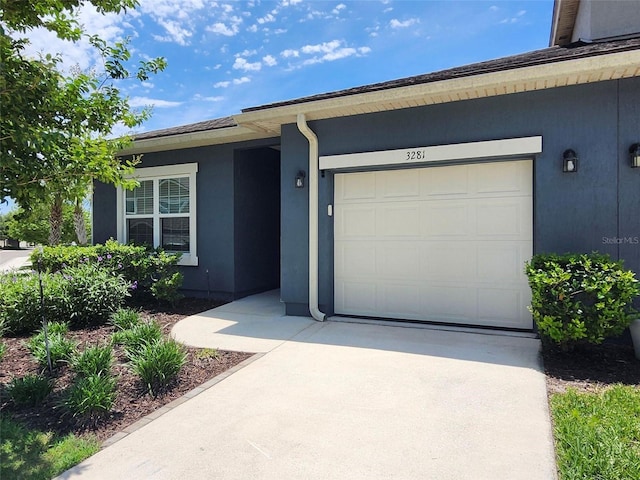3281 Chestnut Ridge Way, Orange Park, FL 32065 - view of front of house with stucco siding, driveway, and a garage
