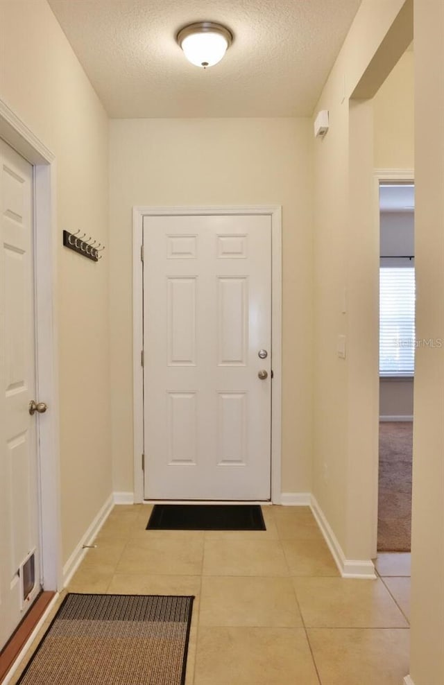 3281 Chestnut Ridge Way, Orange Park, FL 32065 - doorway to outside with light tile patterned floors and a textured ceiling