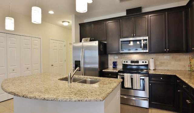 3281 Chestnut Ridge Way, Orange Park, FL 32065 - kitchen featuring stainless steel appliances, backsplash, light stone countertops, decorative light fixtures, and dark brown cabinetry