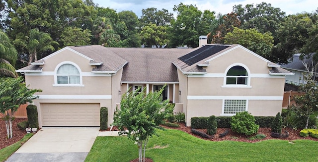 1653 Cheyenne Trl, Maitland, FL 32751 - view of front facade with driveway, a front yard, an attached garage, and stucco siding