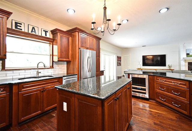 1653 Cheyenne Trl, Maitland, FL 32751 - kitchen with beverage cooler, appliances with stainless steel finishes, a kitchen island, open floor plan, and ornamental molding