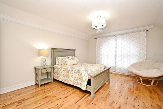 1653 Cheyenne Trl, Maitland, FL 32751 - bedroom with crown molding, light wood-style floors, and a chandelier