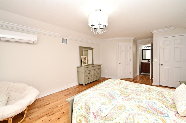 1653 Cheyenne Trl, Maitland, FL 32751 - bedroom with a wall mounted AC, light wood finished floors, crown molding, a chandelier, and ensuite bathroom