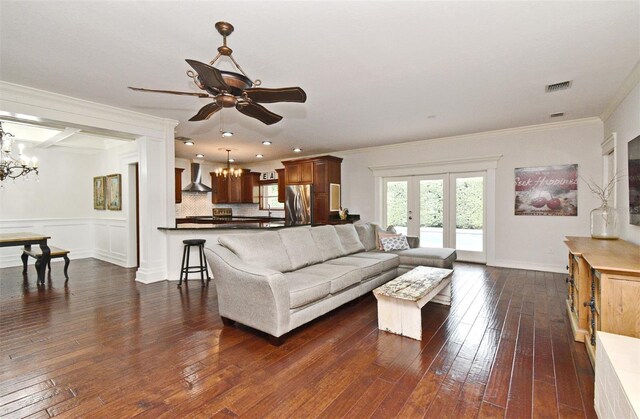 1653 Cheyenne Trl, Maitland, FL 32751 - living area with a chandelier, dark wood finished floors, crown molding, a ceiling fan, and french doors