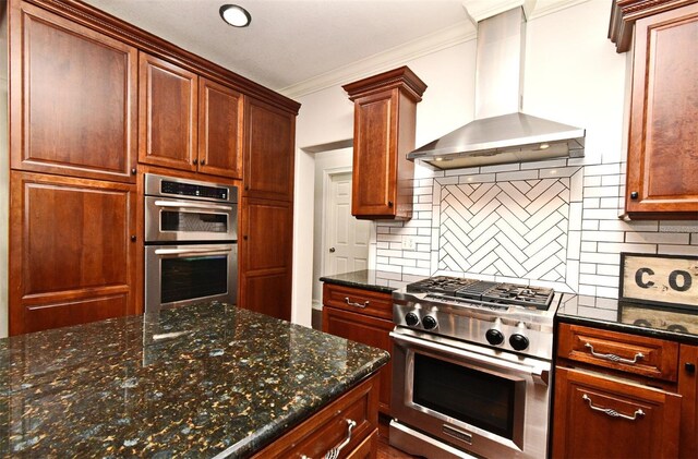 1653 Cheyenne Trl, Maitland, FL 32751 - kitchen featuring wall chimney exhaust hood, appliances with stainless steel finishes, tasteful backsplash, ornamental molding, and dark stone countertops