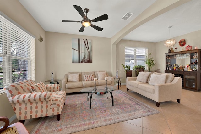 2319 Dammar St, Orlando, FL 32824 - tiled living room with a ceiling fan and arched walkways