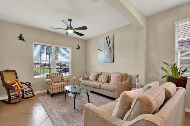 2319 Dammar St, Orlando, FL 32824 - living room with plenty of natural light, a ceiling fan, light tile patterned floors, and arched walkways
