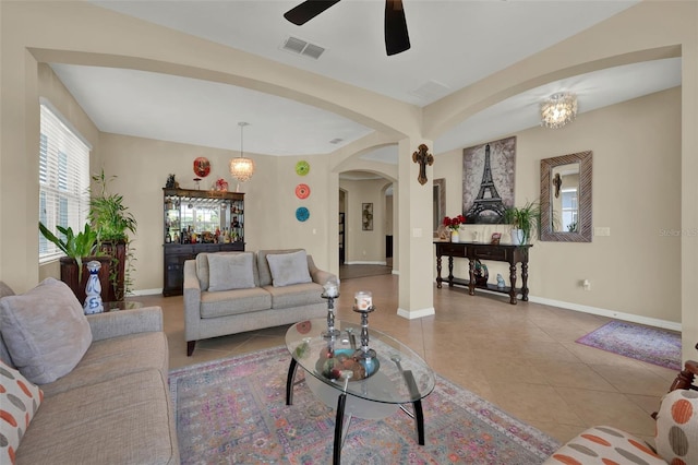 2319 Dammar St, Orlando, FL 32824 - living room featuring tile patterned floors, arched walkways, and a ceiling fan