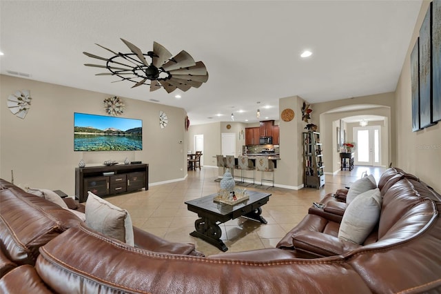 2319 Dammar St, Orlando, FL 32824 - living room featuring arched walkways, light tile patterned flooring, a ceiling fan, and recessed lighting