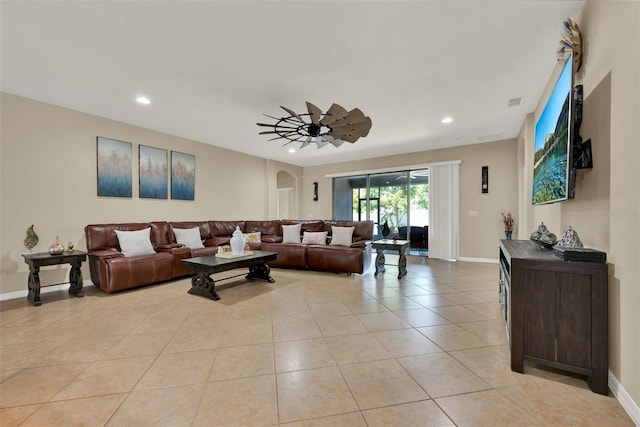 2319 Dammar St, Orlando, FL 32824 - living room featuring light tile patterned floors, recessed lighting, arched walkways, and a ceiling fan