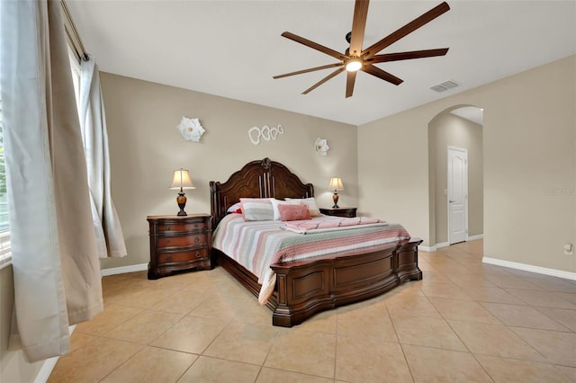 2319 Dammar St, Orlando, FL 32824 - bedroom with arched walkways, light tile patterned floors, and ceiling fan