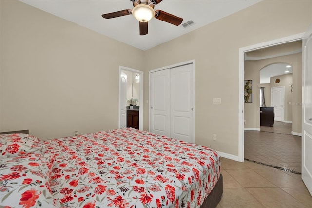 2319 Dammar St, Orlando, FL 32824 - bedroom with light tile patterned floors, arched walkways, a closet, and ceiling fan