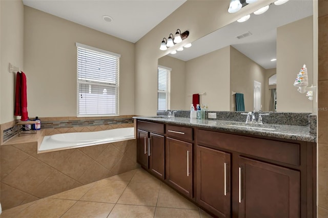 2319 Dammar St, Orlando, FL 32824 - bathroom featuring double vanity, tile patterned floors, and a bath