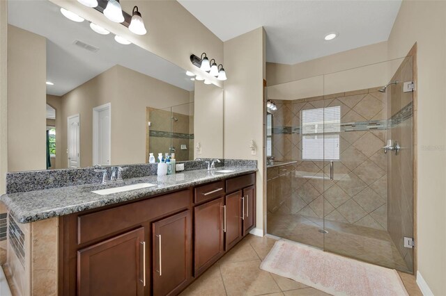 2319 Dammar St, Orlando, FL 32824 - bathroom featuring double vanity, a shower stall, plenty of natural light, and tile patterned flooring