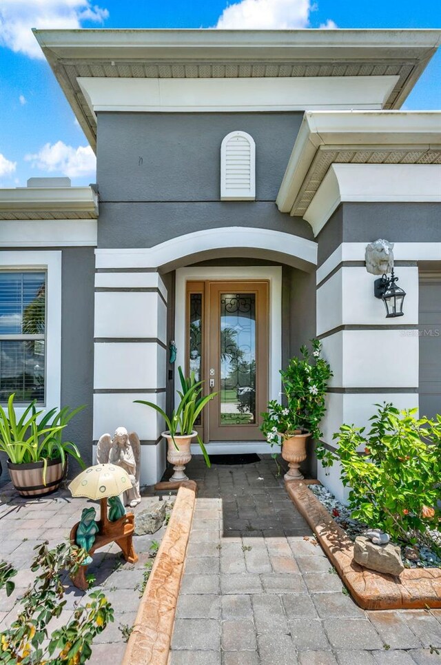 2319 Dammar St, Orlando, FL 32824 - doorway to property featuring stucco siding