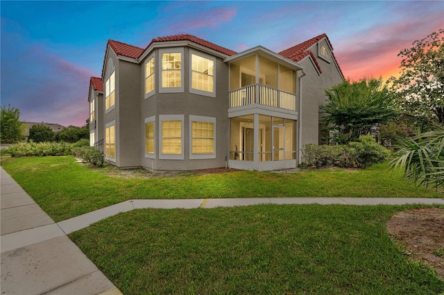 900 Northern Dancer Way Unit 204, Casselberry, FL 32707 - rear view of property featuring a balcony, stucco siding, a lawn, and a tiled roof
