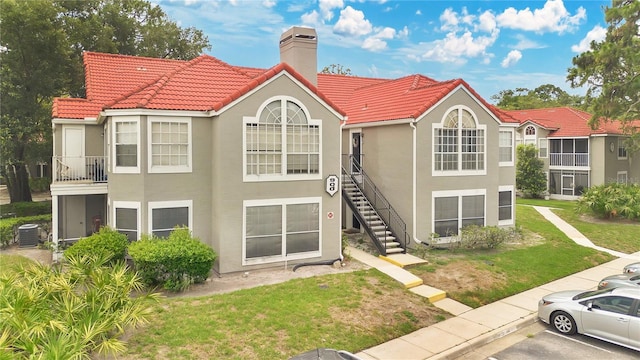900 Northern Dancer Way Unit 204, Casselberry, FL 32707 - back of property with stucco siding, a tiled roof, and stairway