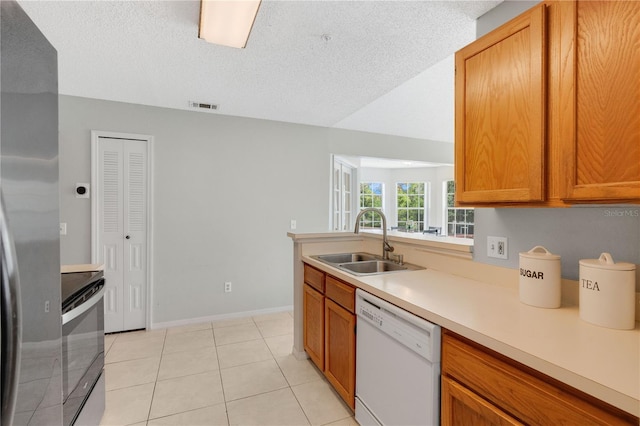 900 Northern Dancer Way Unit 204, Casselberry, FL 32707 - kitchen featuring white dishwasher, stainless steel electric range oven, light countertops, a textured ceiling, and brown cabinetry
