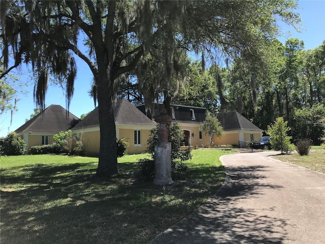 1910 NW 13th Pl, Ocala, FL 34475 - view of front of home with a front yard, driveway, and stucco siding