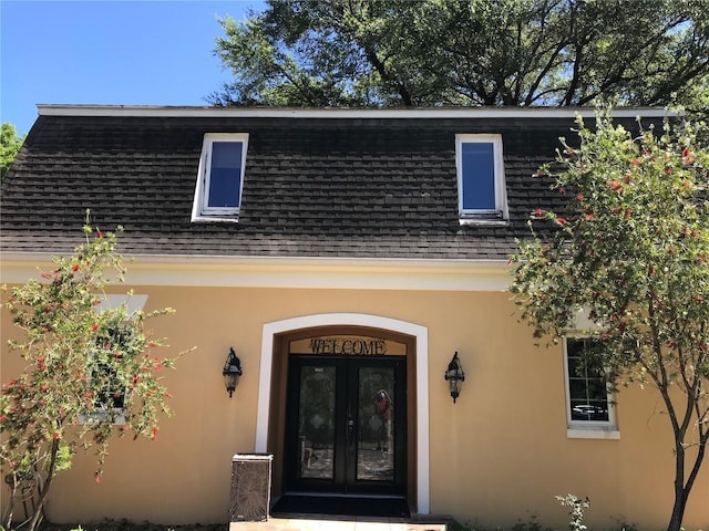 1910 NW 13th Pl, Ocala, FL 34475 - doorway to property with roof with shingles, stucco siding, and french doors