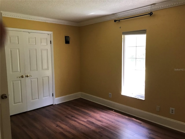 1910 NW 13th Pl, Ocala, FL 34475 - empty room featuring a textured ceiling, dark wood-style flooring, and plenty of natural light