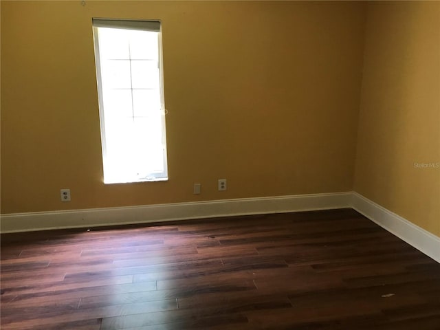 1910 NW 13th Pl, Ocala, FL 34475 - spare room featuring plenty of natural light and dark wood-style flooring