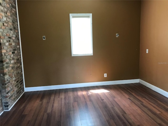 1910 NW 13th Pl, Ocala, FL 34475 - empty room featuring baseboards and dark wood-type flooring
