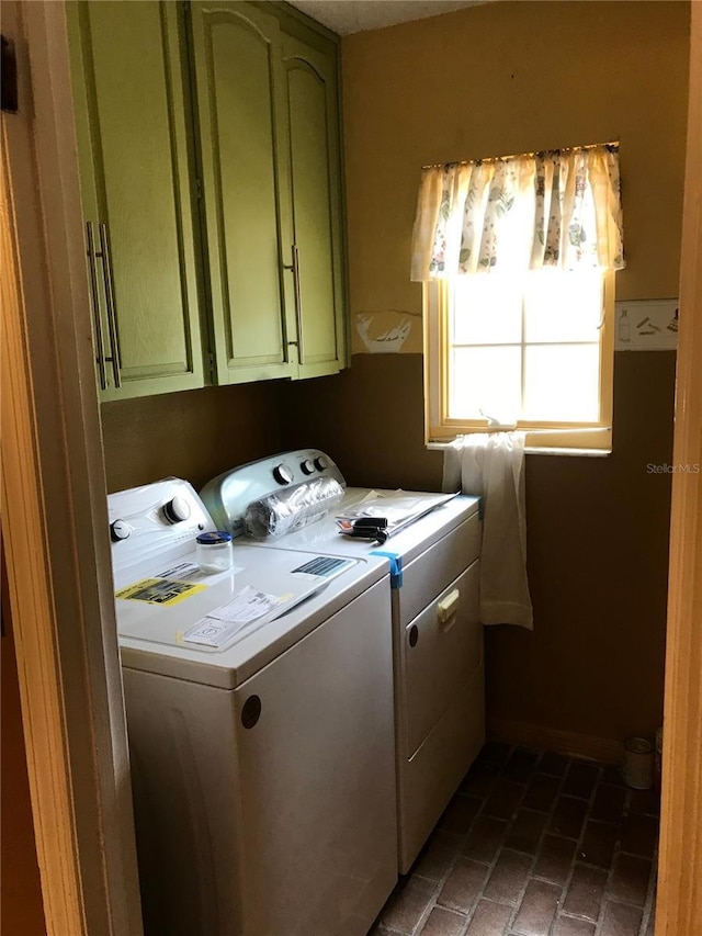 1910 NW 13th Pl, Ocala, FL 34475 - laundry room featuring cabinet space, washing machine and clothes dryer, and brick flooring