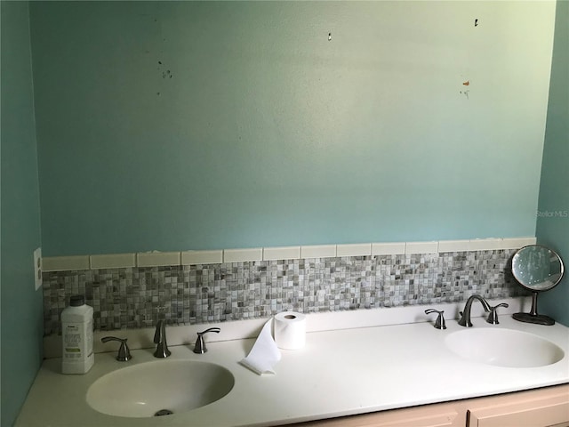 1910 NW 13th Pl, Ocala, FL 34475 - bathroom featuring a sink and decorative backsplash