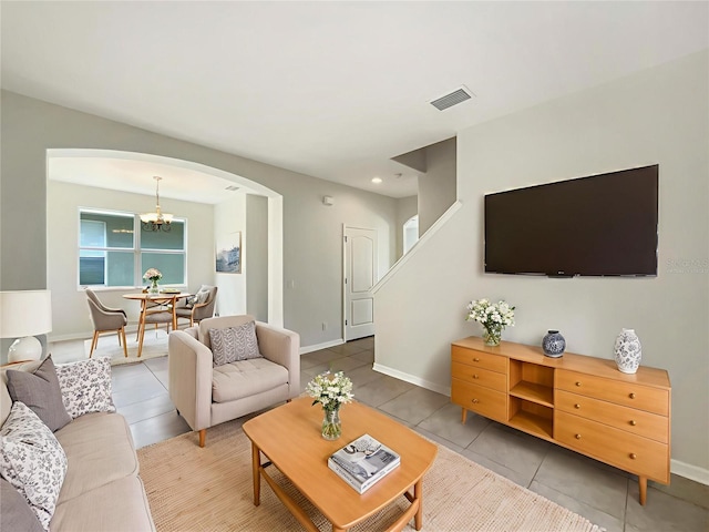 10429 Avelar Ridge Dr, Riverview, FL 33578 - living area featuring arched walkways, tile patterned flooring, and a chandelier