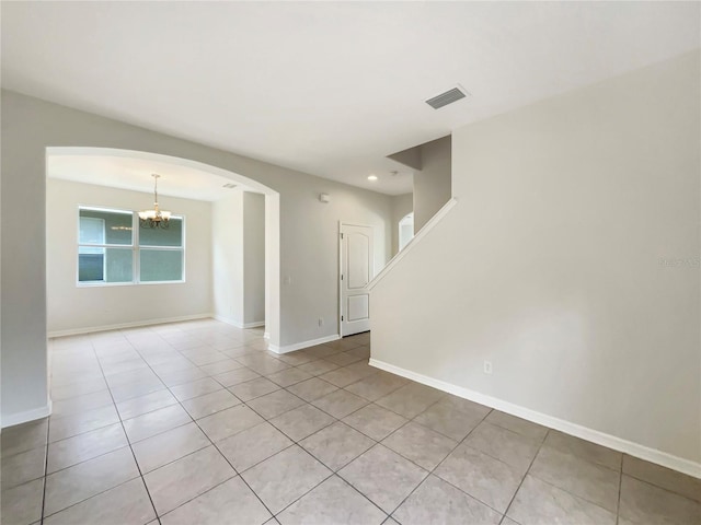 10429 Avelar Ridge Dr, Riverview, FL 33578 - spare room with light tile patterned floors, a chandelier, arched walkways, and recessed lighting