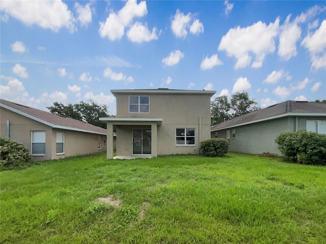 10429 Avelar Ridge Dr, Riverview, FL 33578 - rear view of property featuring stucco siding and a lawn