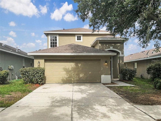 10429 Avelar Ridge Dr, Riverview, FL 33578 - traditional-style house with stucco siding, a garage, driveway, and a shingled roof