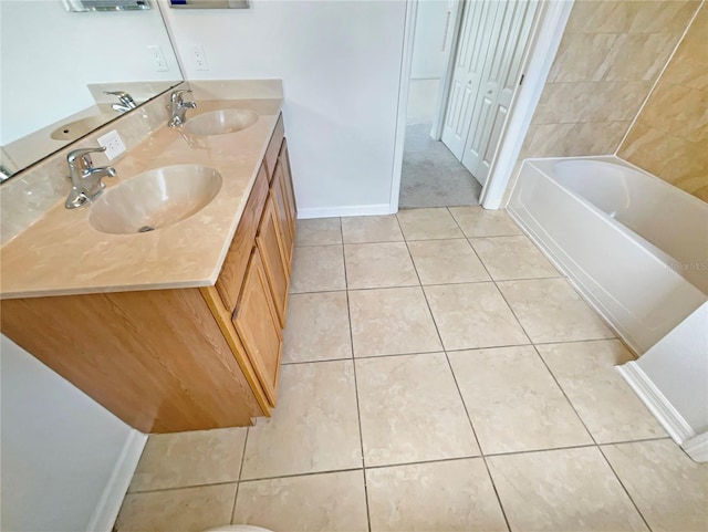 10429 Avelar Ridge Dr, Riverview, FL 33578 - full bath with double vanity, tile patterned flooring, and a bathtub