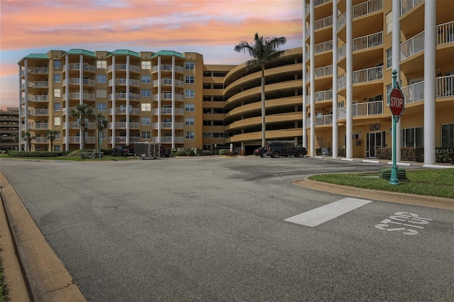 4650 Links Village Dr Unit B103, Ponce Inlet, FL 32127 - property at dusk with uncovered parking and a view of apartment building / complex