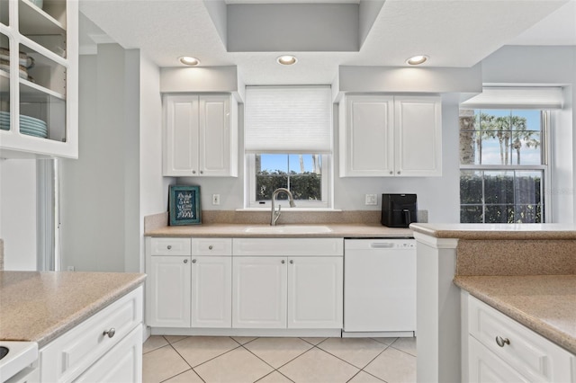 4650 Links Village Dr Unit B103, Ponce Inlet, FL 32127 - kitchen featuring dishwasher, white cabinetry, and plenty of natural light