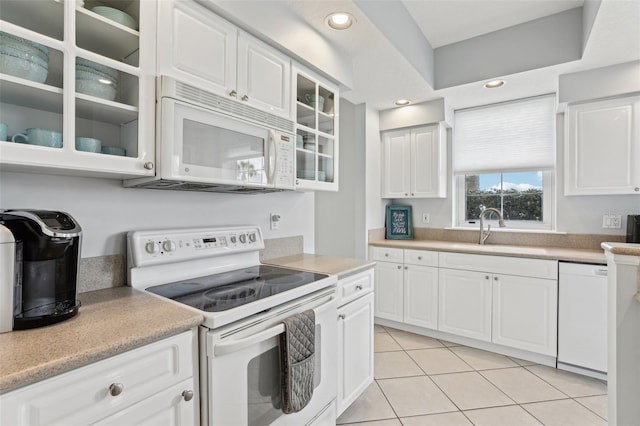 4650 Links Village Dr Unit B103, Ponce Inlet, FL 32127 - kitchen featuring white appliances, glass insert cabinets, light tile patterned floors, light countertops, and recessed lighting