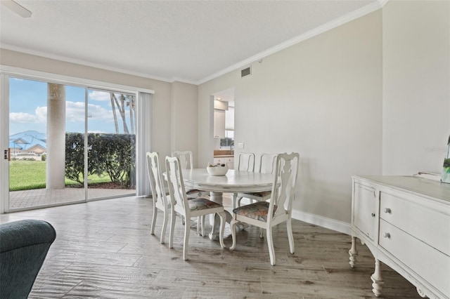 4650 Links Village Dr Unit B103, Ponce Inlet, FL 32127 - dining area featuring crown molding and light wood-style flooring