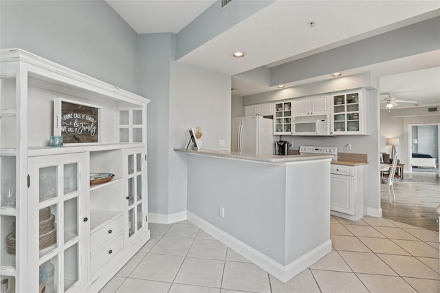4650 Links Village Dr Unit B103, Ponce Inlet, FL 32127 - kitchen with white appliances, light tile patterned floors, white cabinets, glass insert cabinets, and recessed lighting