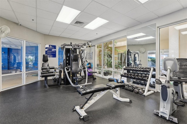 4650 Links Village Dr Unit B103, Ponce Inlet, FL 32127 - gym featuring a paneled ceiling and plenty of natural light