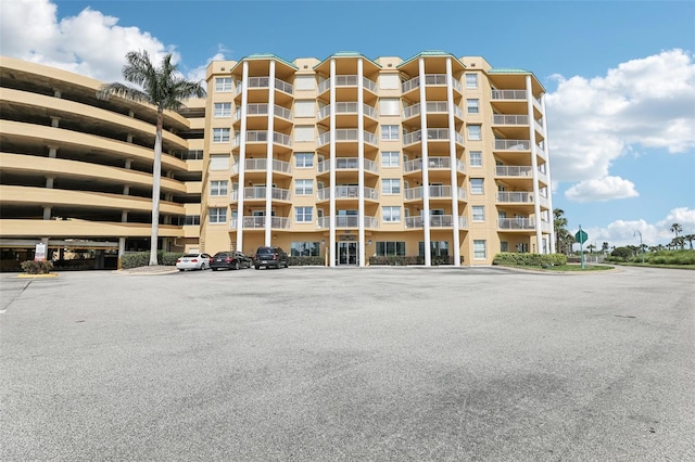4650 Links Village Dr Unit B103, Ponce Inlet, FL 32127 - view of apartment building / complex featuring uncovered parking