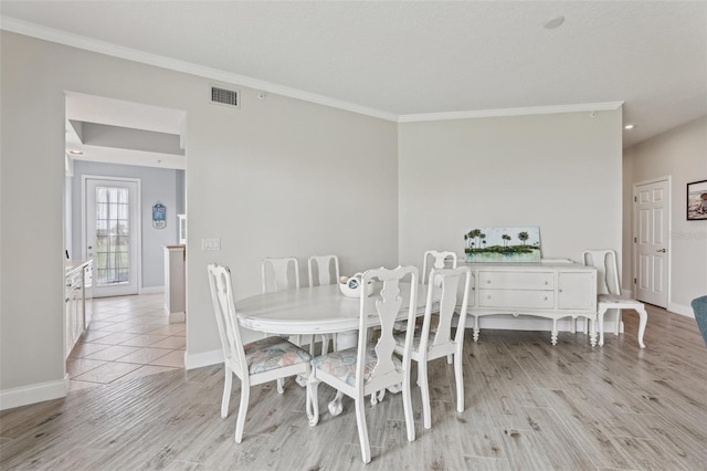 4650 Links Village Dr Unit B103, Ponce Inlet, FL 32127 - dining area with ornamental molding and light wood-type flooring