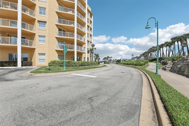 4650 Links Village Dr Unit B103, Ponce Inlet, FL 32127 - view of asphalt road with street lighting, curbs, and sidewalks