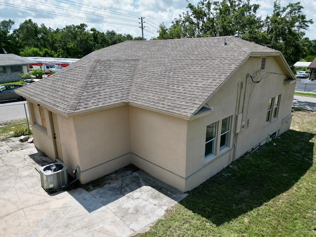 1020 E Main St, Haines City, FL 33844 - view of home's exterior featuring a shingled roof, stucco siding, and a patio