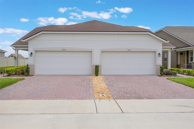 3240 Canna Lily Pl, Clermont, FL 34711 - view of front of home with decorative driveway, stucco siding, a shingled roof, and a garage