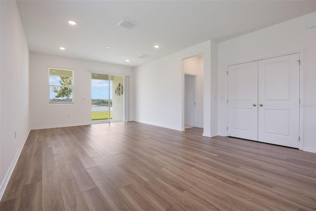 3240 Canna Lily Pl, Clermont, FL 34711 - unfurnished living room with wood finished floors and recessed lighting