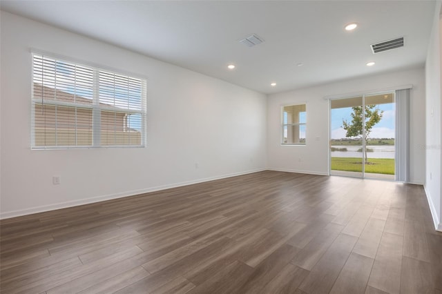 3240 Canna Lily Pl, Clermont, FL 34711 - spare room with dark wood-style flooring, recessed lighting, and a water view
