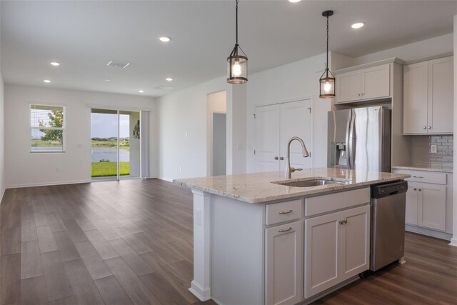 3240 Canna Lily Pl, Clermont, FL 34711 - kitchen featuring stainless steel appliances, open floor plan, dark wood-type flooring, recessed lighting, and an island with sink
