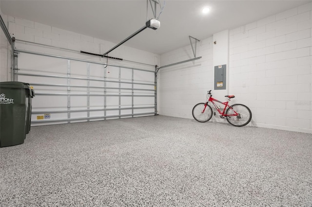 3240 Canna Lily Pl, Clermont, FL 34711 - garage with a garage door opener, electric panel, and concrete block wall