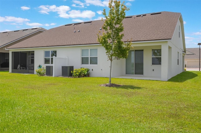 3240 Canna Lily Pl, Clermont, FL 34711 - rear view of property with a shingled roof, a lawn, and stucco siding